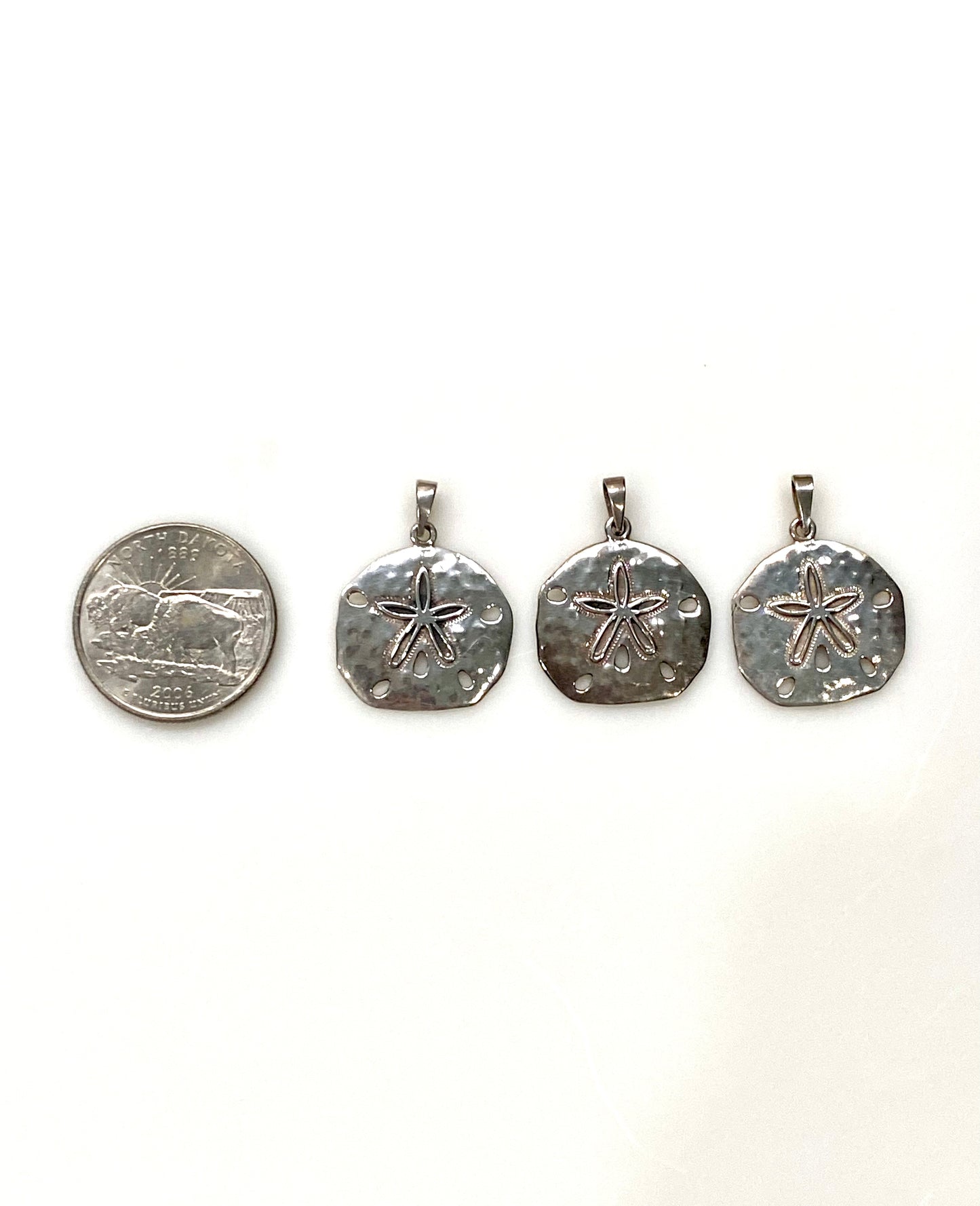 THREE STERLING SILVER SAND DOLLAR CHARM/PENDANTS